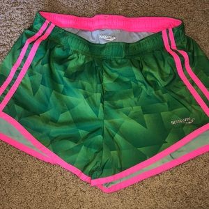 Saucony green and pink running shorts
